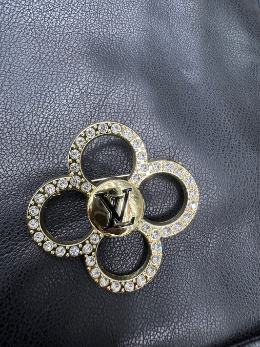 Gold LV brooches