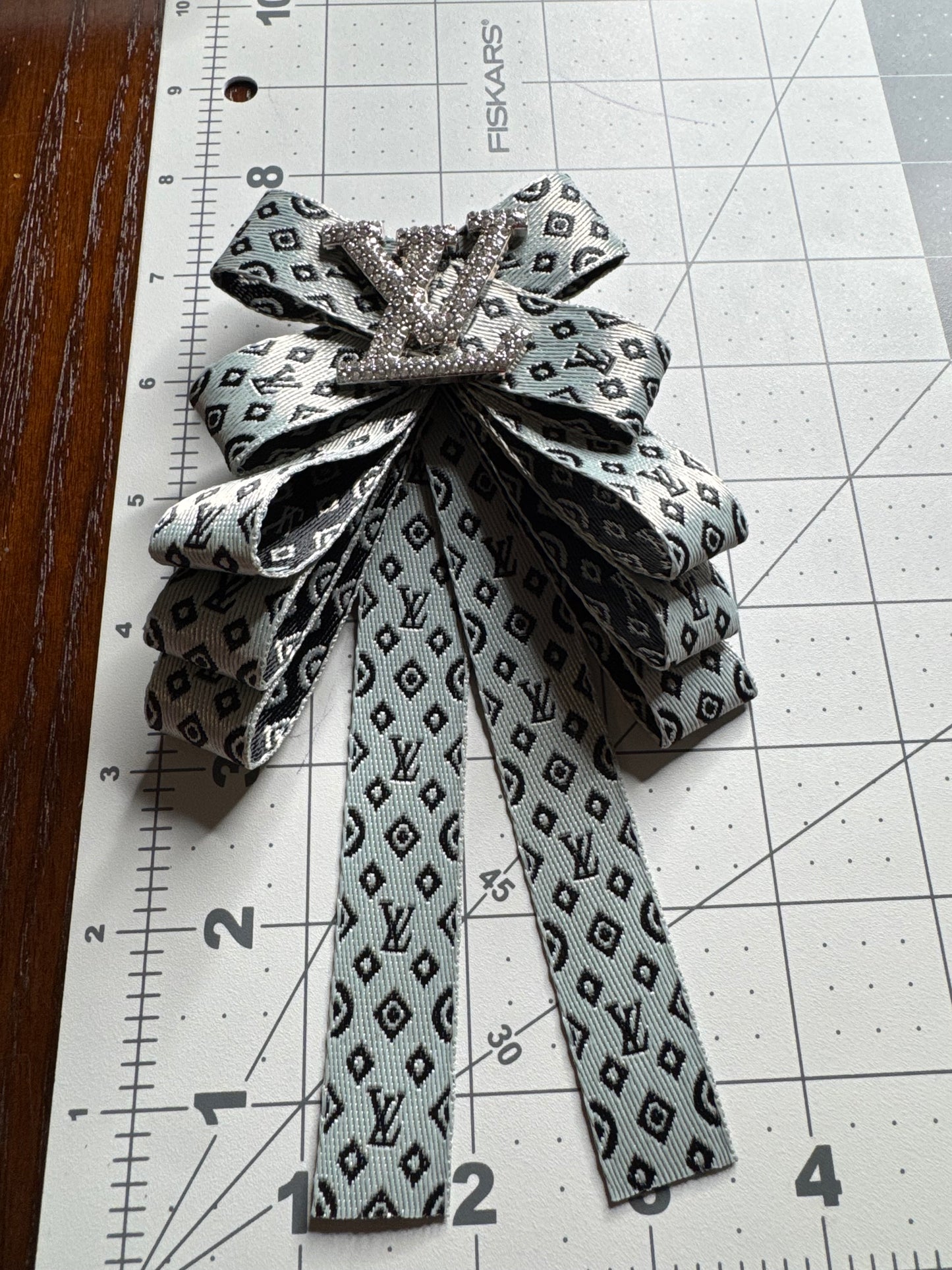 LV bows brooches