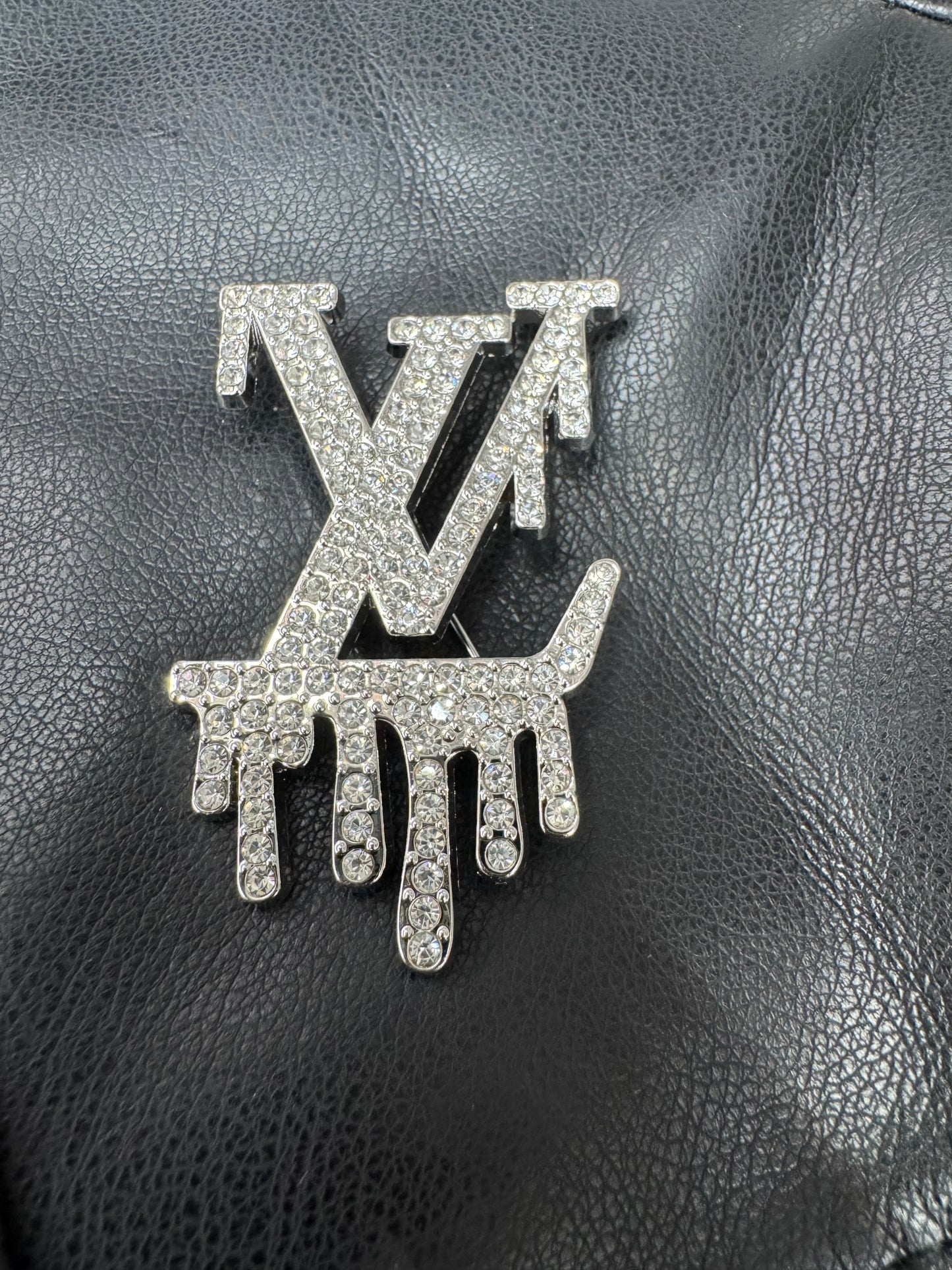 LV drip silver brooch