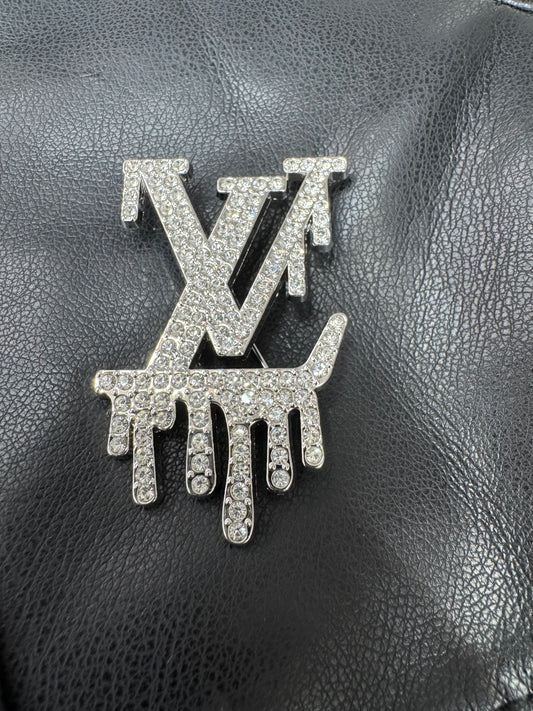 LV drip silver brooch